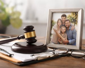 Attorney desk with legal documents, gavel, and family photo representing damages recovered in a Michigan wrongful death lawsuit
